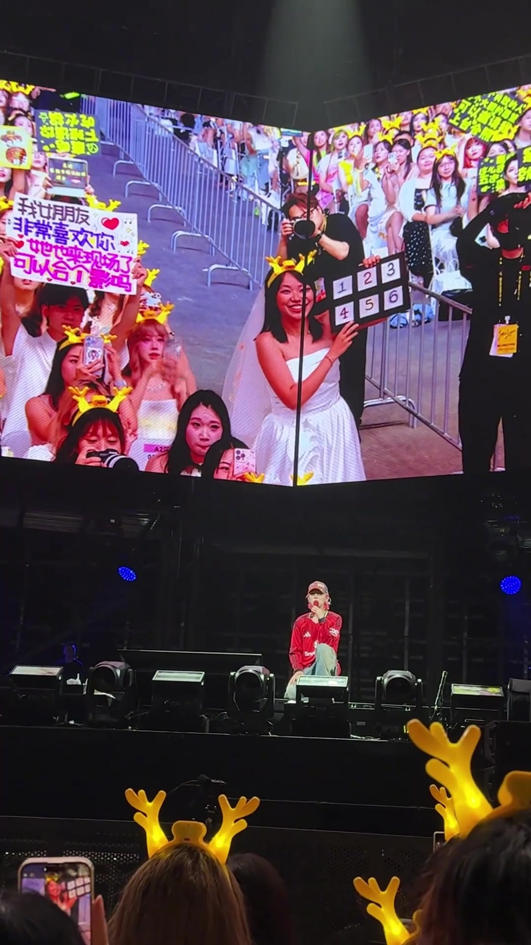 鹿晗在演唱会上身穿曼联新赛季球衣，和身穿婚纱的女粉互动